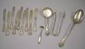 Nine Tiffany  Co Silver Plated Knives a Serving Spoon Small Ladle Serving Tongs and a Stuffing Spoon