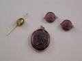 Threepiece Amethyst Glass Suite and a Painted Porcelain Stickpin