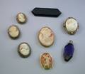 Six Mostly Shell Carved Cameos a Blue Glass Perfume and an Imitation Onyx Brooch