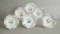 Six reticulated porcelain plates with fruit decoration