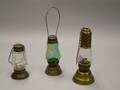 Three Brass and Tin Skaters Lamps