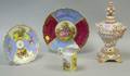 Two Meissenstyle Porcelain Plates a Creamer and a Floral Encrusted Covered Urn on Footed Base