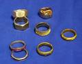 Group of Seven Bands and a Modern Rose Gold and Yellow Gold Bypass Ring