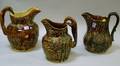 Three Benningtontype Glazed Stoneware Pitchers