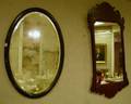 Chippendalestyle Mahogany Mirror and an Oval Black Painted Mirror with Beveled Glass