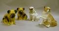 Three Decorated Ceramic Pug Figures and a Pugform Porcelain Container