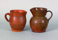 Two redware pitchers 19th c