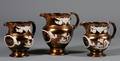 Set of Three English Earthenware Copper Lustre Pitchers
