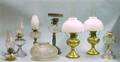Five Assorted Late Victorian Glass Kerosene Table Lamps and a Pair of Aladdin Brass Kerosene Lamps with Milk Gl