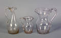 Two blown colorless glass pitchers