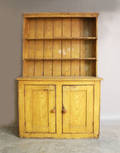 Ochre grain painted stepback cupboard