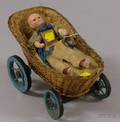 Small Mechanical Wax Head Doll in Basketry Carriage with Painted Wooden Wheels