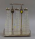 Set of Three German Colorless Cut Glass Decanters in a Silver Plated Tantalus