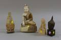 Three Asian Carved Stone Buddhas and a Bronze Bust of Buddha