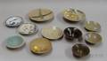 Eleven Korean Blue Celadon and Brown Glazed Saucers