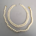 Double strand of 5 mm to 8 mm graduated pearl necklace with platinum clasp and marquise cut diamond