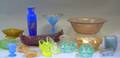 Thirty Colored Pressed Glass Table Items and a FiveBottle Cased Frosted Yellow Glass Cruet Set with Giltmeta