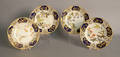 Set of four Royal Worcester plates with reticulated cobalt border and floral decoration