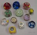 Twelve Faceted Internally Decorated Paperweights