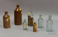 Four Aqua Molded Glass and Three Glazed Stoneware Master Ink Bottles