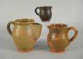 Three redware pitchers