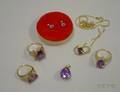 Three Gold and Amethyst Rings a Pair of Amethyst and Gold Earrings and a Amethyst and Gold Pendant