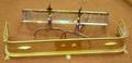 Pierced Silver Plated Brass Fireplace Fender a Pierced Brass Fireplace Fender and a Pair of Wrought Iron Andirons