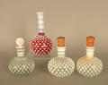 Four opalescent glass bottles