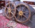 Two Brassmounted Oak Ships Wheels and a Ships Bronze Porthole