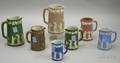 Six Wedgwood Mostly Jasper Dip Jugs and a Wedgwood Copperclad Jug