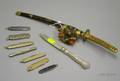 Seven Assorted Penknives a Gorham Silver Handled Fruit Knife and a Miniature Japanese Giltmetal Mounted Lacquered Samurai Sword