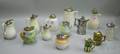 Twelve Assorted Ceramic Syrup Jugs and a Silver Plated Syrup Jug