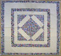 Pieced diamond in square quilt
