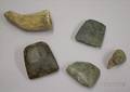 Three Prehistoric Stone Implements a Clay Pipe Bowl and a Pottery Head Fragment