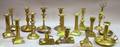 Sixteen Assorted Brass Candlesticks and a Pair of Wick Scissors with Stand