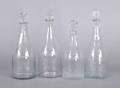 Four wheel engraved colorless glass decanters early 19th c