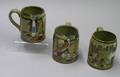 Two Buffalo Pottery Deldare Ware Ye Lion Inn Mugs and an At the Three Pigeons Mug