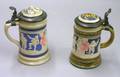 Two Mettlach Relief Decorated Lidded Stoneware Steins