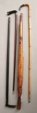 Four canes including one with an alligator carving and another with a silver grip
