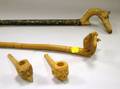 Two Folk Art Carved Walking Sticks with Stylized Animal Finials and Two Carved Figural Pipes