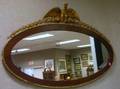 Oval Gilt Gesso and Mahogany Veneer Mirror with Eagle Crest