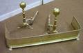 Pair of Brass Balltop Andirons and a Pierced Brass Fireplace Fender