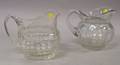 Two Colorless Glass Pitchers