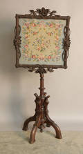 Victorian carved pole screen with needlework panel