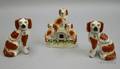 Pair of Staffordshire Spaniels and a Spaniel Figural Group