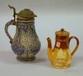 German Cobalt Highlighted Stoneware Flagon and a Doulton Lambeth Glazed Stoneware Teapot