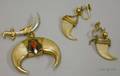 Pair of 14kt Gold Mounted Claw Earrings and a Similar Egyptian Revival Gold and Claw PendantBrooch