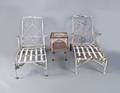 Pair of iron patio lounge chairs together with a table