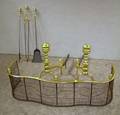 Pair of Brass Andirons a Brass and Wire Serpentine Fender Hearth Shovel and Tongs Set and a Poker