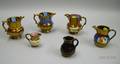 Five English Copper Lusterware Jugs and a Glazed Redware Creamer